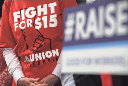  ?? ALEX WONG/GETTY IMAGES ?? An activist wears a “Fight For $15” T-shirt before a vote on the Raise the Wage Act at the U.S. Capitol in 2019. The legislatio­n would raise the federal minimum wage from $7.25 to $15 by 2025.