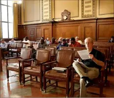  ?? Andrew Rush/Post-Gazette ?? Potential bidders listen during a city Treasurer’s Sale at the City-County Building in April.