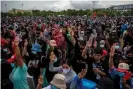  ??  ?? Anti-government protesters hold up a three-finger salute during a rally at Sanam Luang on Sunday. Photograph: Lauren DeCicca/Getty Images