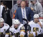  ?? CP PHOTO DARRYL DYCK ?? Vegas Golden Knights head coach Gerard Gallant stands behind the bench during a preseason NHL hockey game against the Vancouver Canucks in Vancouver on Sept. 17.