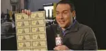  ?? DONN PEARLMAN ?? Reporter Paul Milliken of Fox 5 Atlanta happily held an uncut sheet of $100,000 notes on TV in 2014.