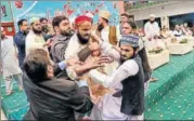  ?? AFP ?? ▪ Pakistani security personnel and organisers of a gathering tackle one of the men who threw a shoe at Nawaz Sharif.