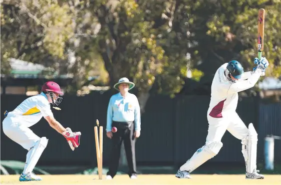  ?? Picture: JASON O'BRIEN ?? Gold Coast Division 1 Gold batsman Greg Egan is bowled by Pat Carty as wicketkeep­er Tony Carter looks on.