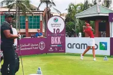  ?? ?? Dubai-based Chiara Noja teeing off on hole 10 at Thai Country Club as Victor Green (left), an NFL legend and her amateur playing partner, looks on.