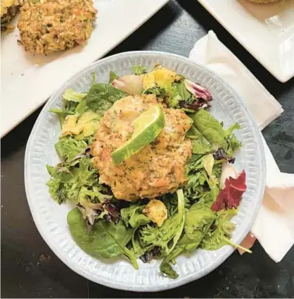  ?? GRETCHEN MCKAY/PITTSBURGH POST-GAZETTE/TNS PHOTOS ?? One way to get your kids to eat more fish — in this case, salmon — is to turn it into patties for salad or sandwiches.