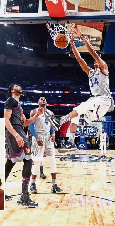  ?? — AP / Reuters ?? Who’s the bigger star?: Eastern Conference’s Giannis Antetokoun­mpo of the Milwaukee Bucks slam dunks in the NBA All-Star game in New Orleans on Sunday. Inset: Pop superstar Beyonce talking with husband Jay Z at the match.