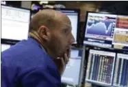  ?? RICHARD DREW — THE ASSOCIATED PRESS ?? Specialist Meric Greenbaum works at his post on the floor of the New York Stock Exchange Friday.