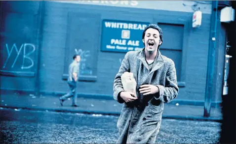  ??  ?? Paul McCartney is photograph­ed by wife Linda as he strolls in Glasgow in 1970 in this picture from the new exhibition