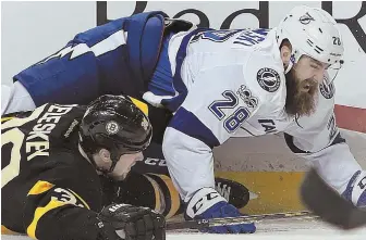  ?? STAFF PHOTO BY MATT STONE ?? ON ICE: Matt Beleskey and Tampa Bay’s Luke Witkowski hit the deck after colliding during the first period of last night’s game at the Garden.