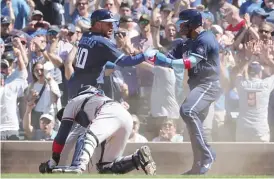  ?? GETTY IMAGES ?? Jonathan Villar celebrates with Willson Contreras after scoring in the eighth inning.