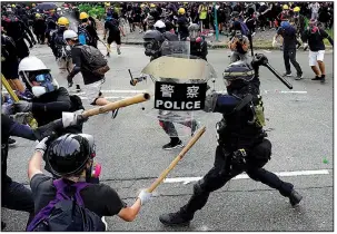  ?? AP/VINCENT YU ?? Police and demonstrat­ors clash during Saturday’s protests in Hong Kong.