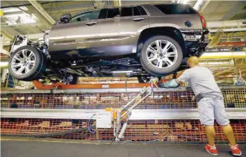  ?? — Reuters ?? A man inspects a GM SUV at General Motor’s plant in Detroit.