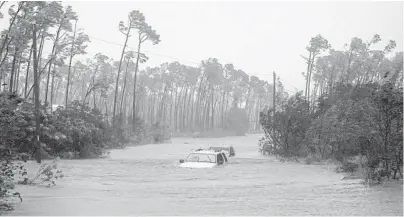  ?? RAMON ESPINOSA/AP ?? Cars sit submerged in water from Hurricane Dorian in Freeport, Bahamas on Tuesday.