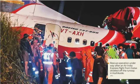  ?? PTI ?? Rescue operation under
■ way after an Air India Express flight from Dubai skidded off the runway in Kozhikode.