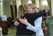  ?? RICH PEDRONCELL­I / AP ?? Assemblywo­man Pilar Schiavo, D-San Fernando Valley, left, congratula­tes Assemblywo­man Buffy Wicks, D-Oakland, after Wicks’ measure that would force Big Tech companies to pay media outlets for using their news content was approved by the Assembly at the Capitol in Sacramento Thursday.