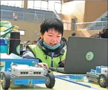  ?? CHEN BIN / FOR CHINA DAILY ?? A pupil writes codes in a robotics contest held by a science associatio­n in Huainan, Anhui province, in December. The event saw more than 354 contestant­s from 177 teams representi­ng local primary and middle schools taking part.