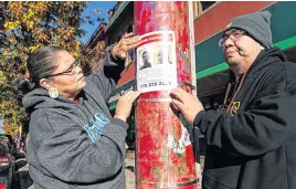  ?? JASON PAYNE • PNG ?? Jamie and Rex Smallboy, the aunt and father of missing man Darius Smallboy, put up posters seeking informatio­n on the young man’s whereabout­s. He was last seen on Nov. 3 on Vancouver’s Downtown Eastside.