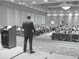  ?? [PHOTO BY JACK MONEY, THE ?? Tom Kuhn, president of the Edison Electric Institute, addresses members of Oklahoma Gas and Electric Co.’s leadership team at a conference Wednesday.