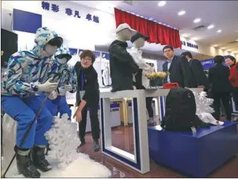  ?? ZOU HONG / CHINA DAILY ?? Customers visit one of the first franchise stores selling licensed products for the 2022 Beijing Winter Olympic Games and Paralympic Games in Beijing on Wednesday.