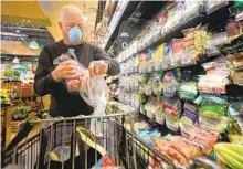  ?? HOWARD LIPIN U-T ?? Chuck Pennell of Bankers Hill shops at Barons Market, North Park, during seniors-only time, a byproduct of the coronaviru­s outbreak.