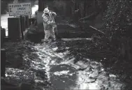  ?? GENARO MOLINA/LOS ANGELES TIMES ?? Cal Portland constructi­on worker Tanner Casner clears mud away to let water from the recent storm drain into Buena Vista Creek in Montecito on Friday.