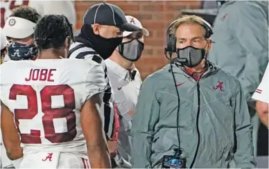  ?? AP PHOTO/ ROGELIO V. SOLIS ?? Alabama football coach Nick Saban, right, speaks with defensive back Josh Jobe during the second half of the team's game at Ole Miss this past Saturday night. The Crimson Tide won 63-48 to remain undefeated ahead of this weekend's home game against Georgia, but Saban learned Wednesday he has tested positive for COVID-19.