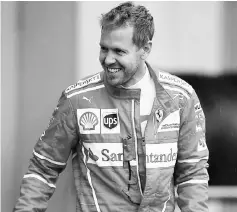  ?? — AFP photo ?? Vettel walks in the paddock before the start of the second practice session of the Formula One Japanese Grand Prix in Suzuka.