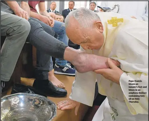  ??  ?? Pope Francis kisses an inmate’s feet and blows in an amphora (below) containing holy oil on Holy Thursday.