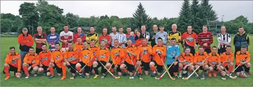  ??  ?? The Shinty All Stars and Taynuilt/Kilmory Select pose with Yvonne MacHugh, Billy’s fiancée, and their son William, at the match to raise funds for Billy’s plight.