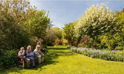  ??  ?? Visitors enjoy the early summer sunshine