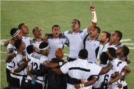  ??  ?? Fiji’s players huddle, with Ben Ryan in black jacket, after winning the gold in Rio. Photograph: Philippe Lopez/AFP/Getty Images