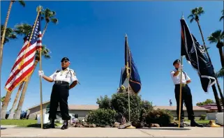  ??  ?? MEMBERS OF THE POW-MIA-KIA HONOR GUARD ORGANIZATI­ON stand in front of a local mortuary keeping McCain on Sunday in Phoenix.