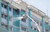  ?? ANI ?? Municipal workers spray disinfecta­nt on the building of Rajiv Gandhi Government General Hospital in Chennai on Wednesday.