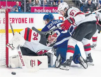  ?? MARK BLINCH GETTY IMAGES ?? Devils goalie Jake Allen defends his net against Leafs forward Tyler Bertuzzi on Tuesday night.