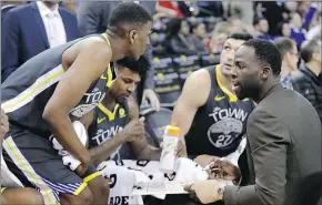  ?? AP PHOTO ?? Golden State Warriors’ Draymond Green (right), who was injured, calls a play from the bench during Monday’s game against the Phoenix Suns.