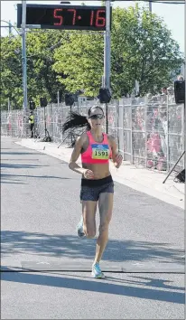  ?? JOE GIBBONS/THE TELEGRAM ?? Jennifer Murrin says she has never thought of herself as an elite runner, but she has earned the tag with a run to a championsh­ip in Sunday’s Tely 10. It was her sixth win in six local road races this year.