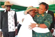  ?? ?? Environmen­tal patron First Lady Dr Auxillia Mnangagwa hugs environmen­tal enthusiast Mirabelle Gavi while Minister of State and Devolution for Harare Senator Charles Tawengwa looks on during the launch of a model children’s green park in Glen Norah, Harare yesterday