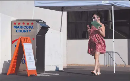  ?? Photo: Nampa/AFP ?? Interestin­g battle… A woman deposits her mail-in ballots for the US presidenti­al election at a ballot collection box in Phoenix, Arizona.