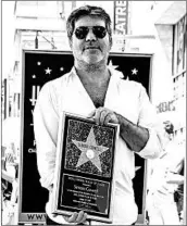  ?? RICH FURY/GETTY ?? Simon Cowell attends a ceremony honoring him with a star on the Hollywood Walk of Fame in August.