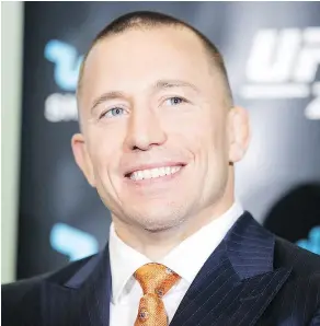  ?? — CP PHOTO ?? Canadian Georges St-Pierre absorbed a few verbal shots from rival Michael Bisping Friday when they were in Toronto to promote their UFC 217 middleweig­ht title bout Nov. 4 in New York.