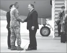  ?? Jung Yeon-je/Pool Photo via AP ?? Meeting: U.S. Secretary of State Mike Pompeo, center, shakes hands with U.S. General Vincent K. Brooks, commander of United States Forces Korea, upon his arrival at Osan Air Base in Pyeongtaek Wednesday. South Korea's presidenti­al office said Pompeo...