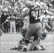  ?? FILE PHOTO ?? Former New Orleans Saints kicker Tom Dempsey (19) boots a once-record 63-yard field goal in 1970. He died Saturday.