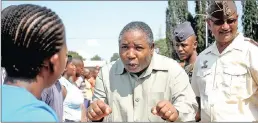  ??  ?? Charles Nqakula gets into the spirit of things as he motivates new recruits ahead of their basic training, when he was defence minister, as Lieutenant-general Vejaynand Ramlakan, listens.