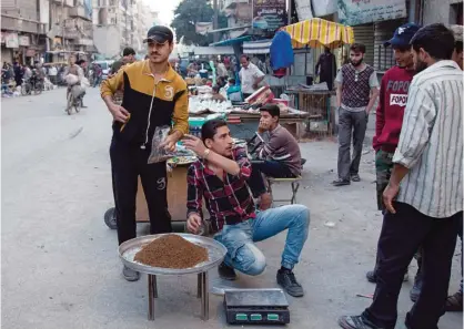  ??  ?? ALEPPO: A Syrian man sells tobacco in the rebel-held side of the northern embattled city of Aleppo. —AFP