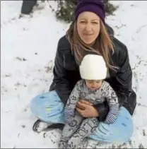  ?? PHOTO courtesy OF brantley FARRIS ?? Former lowell resident george Kalergis’ daughter Hailee Farris and his grandson dazen Farris outside in the remains of the winter storm that struck the city of magnolia, texas.