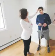  ??  ?? Boston Marathon bombing victim Jeff Bauman and his fiancée, Erin Hurley, stand in a room that will soon be a nursery in their Carlisle, Mass., home. Charles Krupa, AP