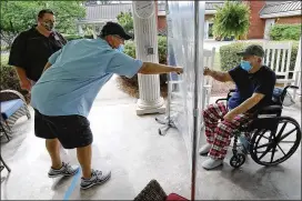  ?? PHOTOS BY CURTIS COMPTON / CCOMPTON@AJC.COM ?? COVID-19 survivor Francis “Tom” Holland, 93, fist-bumps son Johnny Holland as grandson John Holland looks on June 5, the first day families could do pavilion visits with loved ones at Westbury Medical Care and Rehab in Jackson.