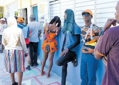  ?? RUDOLPH BROWN/PHOTOGRAPH­ER ?? Residents of Kingston Central waiting at polling station at the First Missionary Church to cast their votes in the local government elections on Monday.