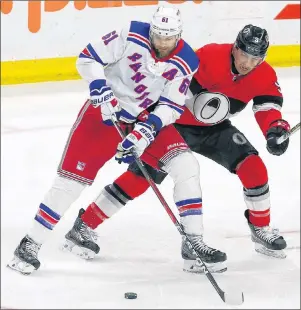  ?? CP PHOTO ?? Ottawa Senators defenceman Cody Ceci, right, and New York Rangers right-winger Rick Nash battle for the puck during Saturday’s game in Ottawa. Nash is one of the big names on the trade market.