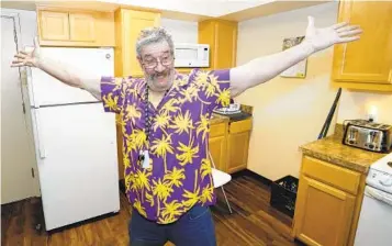  ?? RICH PEDRONCELL­I AP ?? Thomas Marshall shows off the kitchen in his one-bedroom apartment in Sacramento. “Living here has just improved my well-being in every possible way,” said Marshall, who had been homeless.